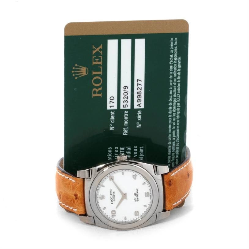The Rolex Cellini 5320 Men's White Gold White Dial 5320 Men's White Gold White Dial watch is shown from a front angle with its accompanying authentication card.