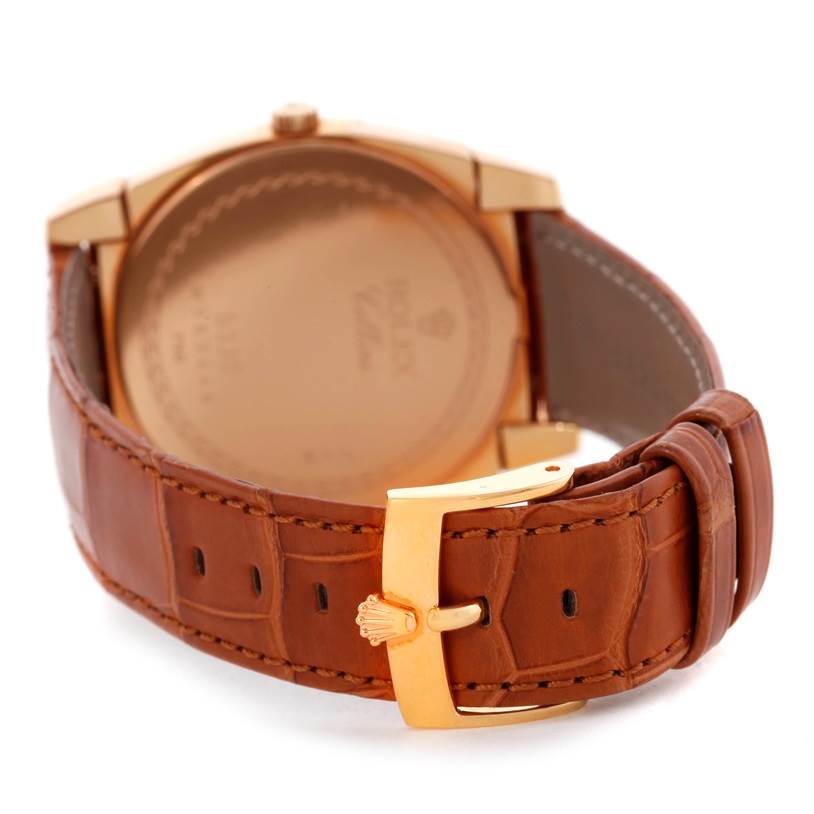 This image showcases the back and clasp of a Rolex Cellini 5330 Men's Rose Gold White Dial 5330 Men's Rose Gold White Dial watch, featuring a brown leather strap and gold buckle.