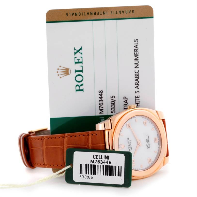The image shows the side view of a Rolex Cellini 5330 Men's Rose Gold White Dial 5330 Men's Rose Gold White Dial watch with its identification card behind it.