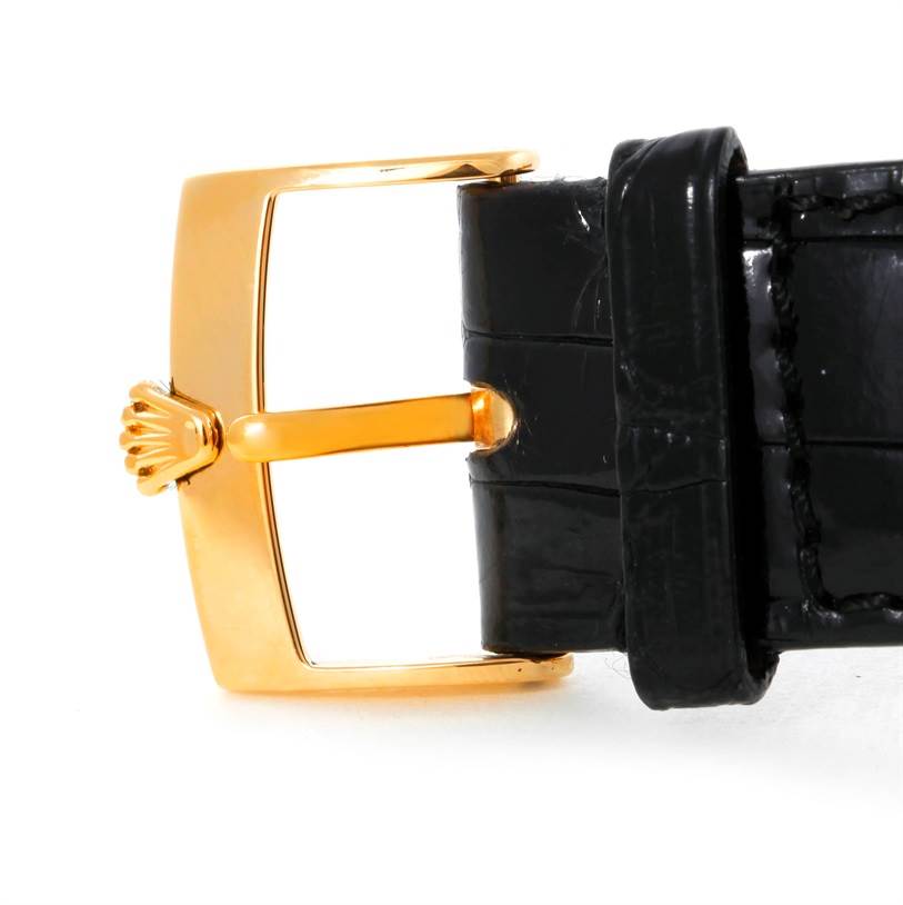 The image shows a close-up of the buckle and strap of a Rolex Cellini 4233 Men
s Yellow Gold Black Dial 4233 Men
s Yellow Gold Black Dial watch, focusing on the gold-tone buckle and black leather strap.