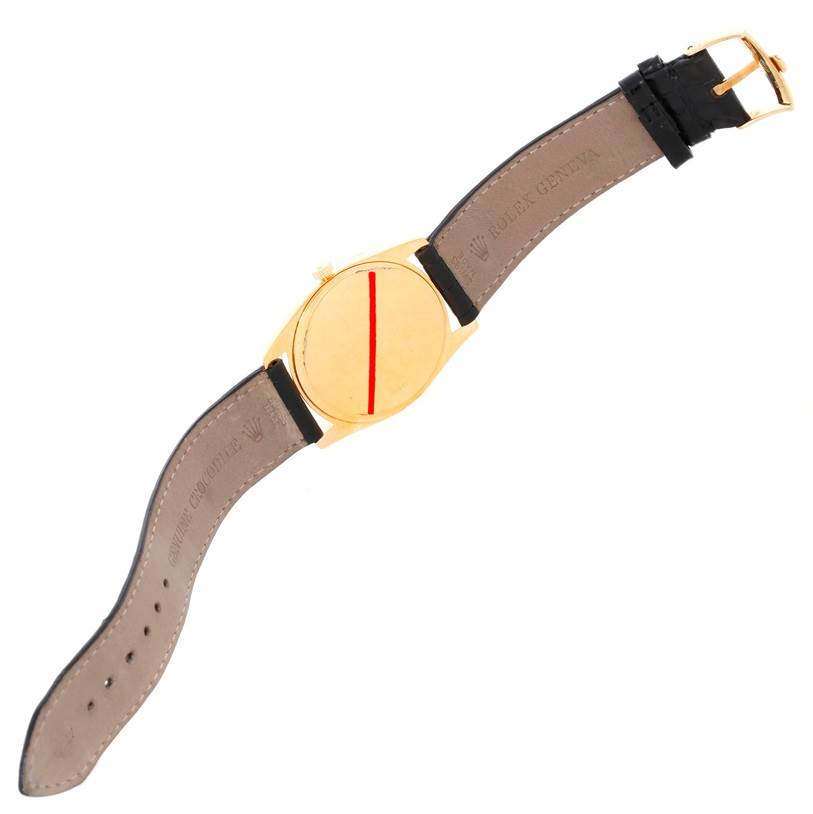 The image shows the rear view of a Rolex Cellini 4233 Men
s Yellow Gold Black Dial 4233 Men
s Yellow Gold Black Dial watch, displaying its case back, leather strap, and buckle.