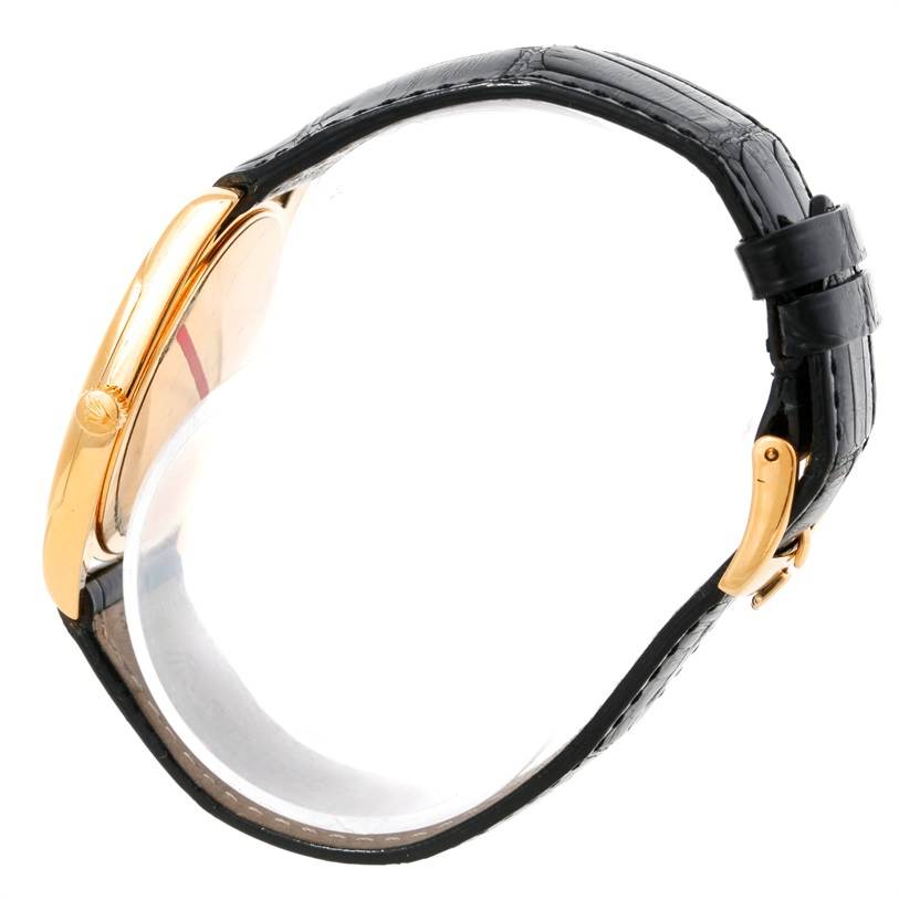 The image shows a side view of a Rolex Cellini 4233 Men
s Yellow Gold Black Dial 4233 Men
s Yellow Gold Black Dial watch, highlighting the profile, gold case, and black leather strap.