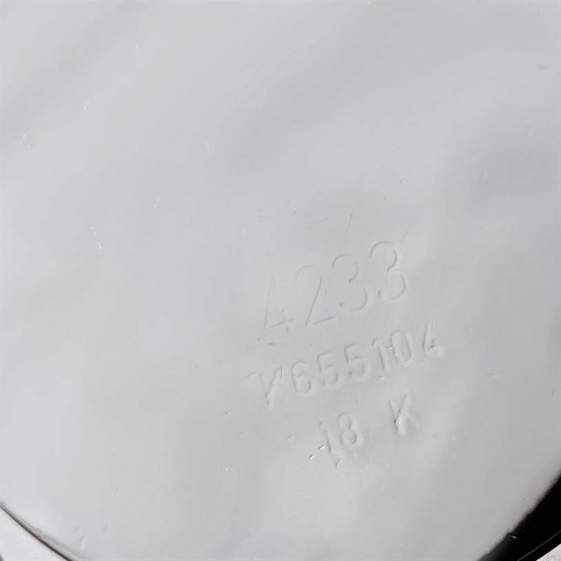 This image shows an angled view of the back of a Rolex Cellini 4233 Men's White Gold White Dial 4233 Men's White Gold White Dial watch, displaying engraved details including the model number and gold purity mark.
