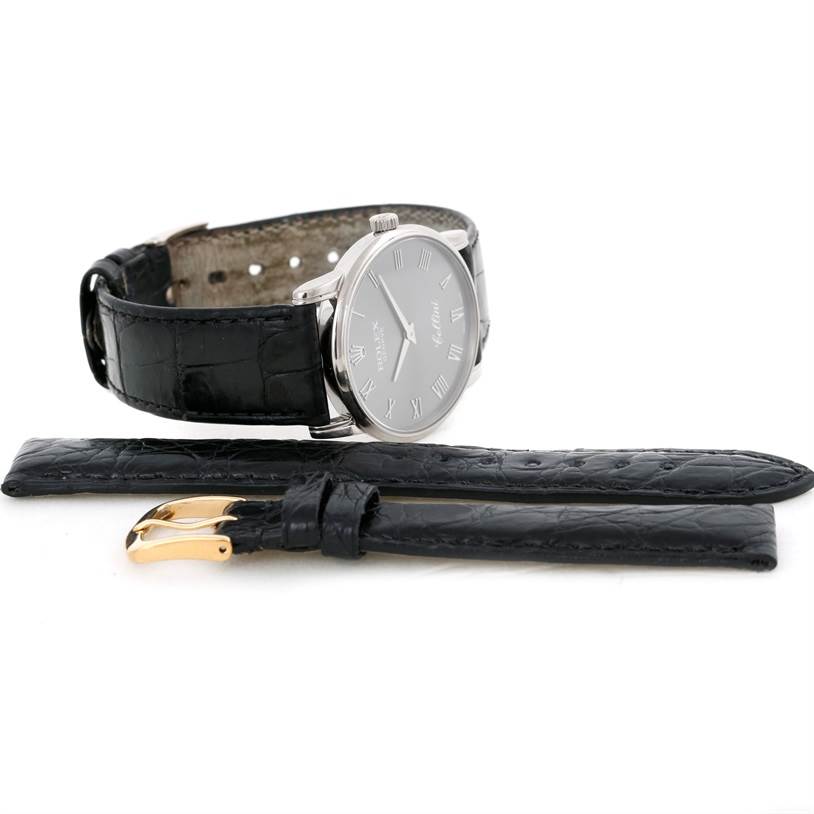 This image shows a side view of a Rolex Cellini 5116 Men's White Gold Grey Dial 5116 Men's White Gold Grey Dial watch with an additional black leather strap and gold buckle.