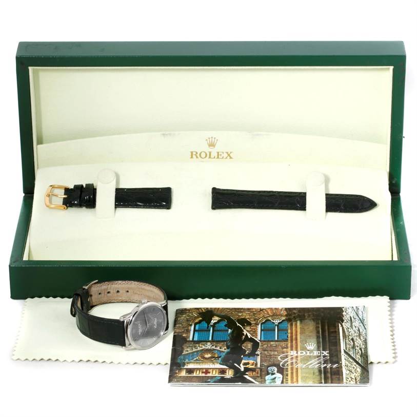 This image shows a Rolex Cellini 5116 Men's White Gold Grey Dial 5116 Men's White Gold Grey Dial watch, its box, an extra strap, a cloth, and a booklet, photographed from the front.