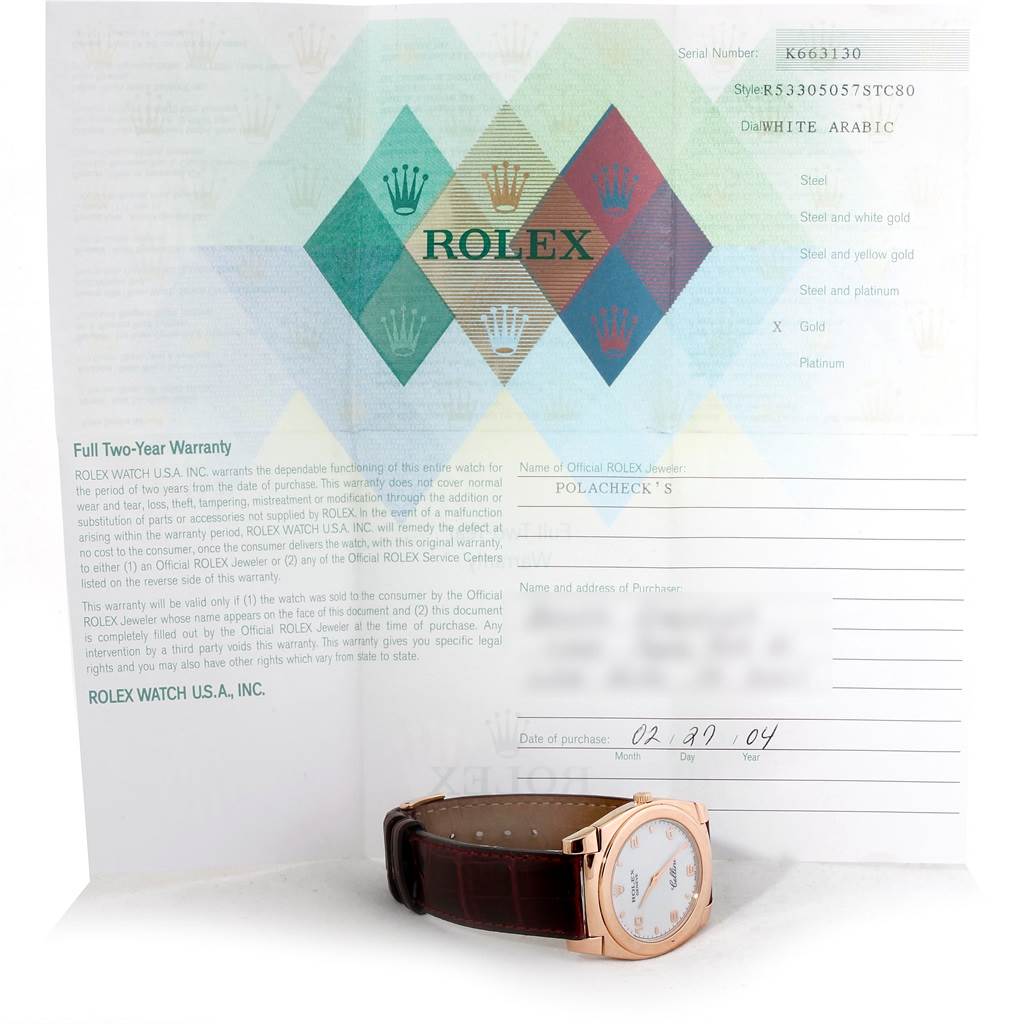 The image shows a Rolex Cellini 5330 Men's Rose Gold White Dial 5330 Men's Rose Gold White Dial watch placed in front of its warranty booklet, viewed at a slight angle from above.