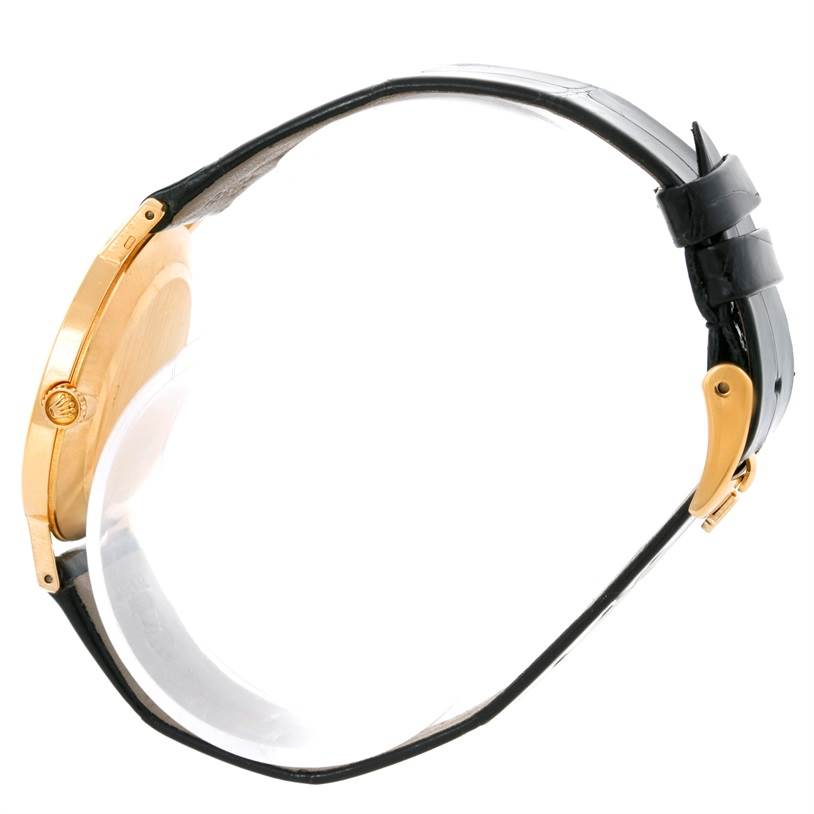 The image shows a Rolex Cellini 5112 Men's Yellow Gold Mother of Pearl Dial 5112 Men's Yellow Gold Mother of Pearl Dial watch from a side angle, highlighting its crown, case, and leather strap with a buckle.