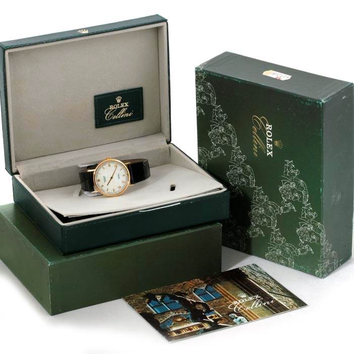 The image shows a Rolex Cellini 5112 Men's Yellow Gold Mother of Pearl Dial 5112 Men's Yellow Gold Mother of Pearl Dial watch in its open box, surrounded by its outer box and promotional materials.