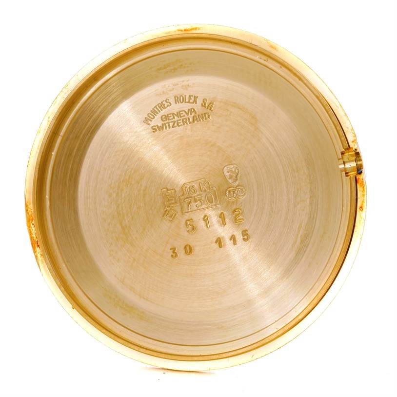 This image shows the inner case back of a Rolex Cellini 5112 Men's Yellow Gold Mother of Pearl Dial 5112 Men's Yellow Gold Mother of Pearl Dial watch with engravings and hallmarks.