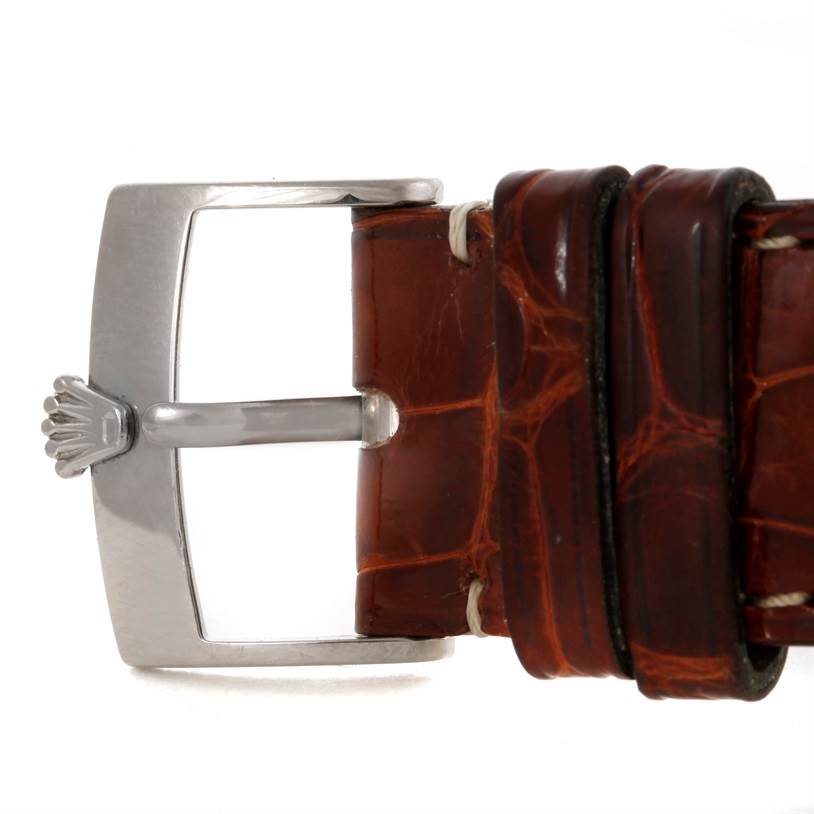 This image shows the buckle and part of the brown leather strap of a Rolex Cellini 5330 Men's White Gold Mother of Pearl Dial 5330 Men's White Gold Mother of Pearl Dial watch.