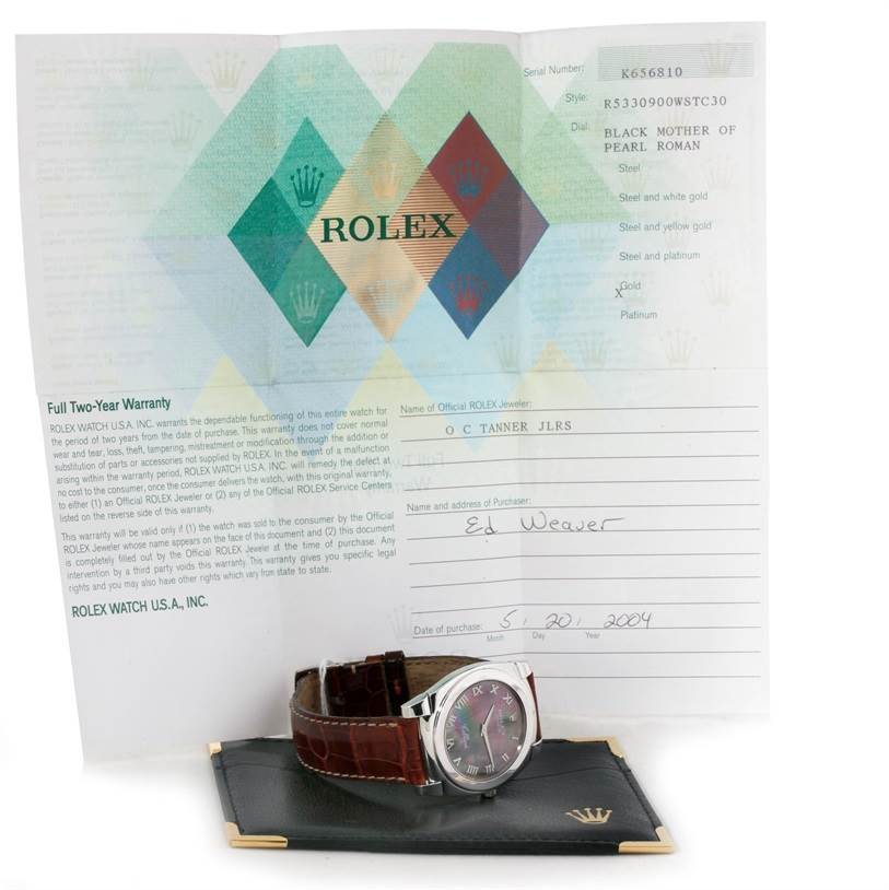 The Rolex Cellini 5330 Men's White Gold Mother of Pearl Dial 5330 Men's White Gold Mother of Pearl Dial watch is shown at an angle with its warranty card behind it.