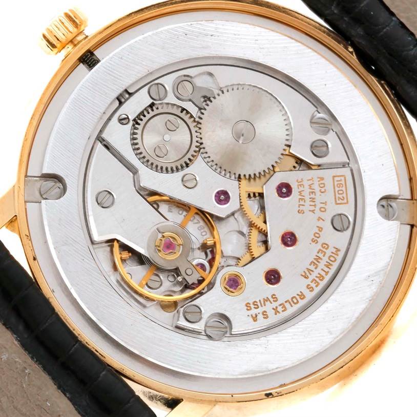 The image shows the back view of a Rolex Cellini 5115 Men
s Yellow Gold Champagne Dial 5115 Men
s Yellow Gold Champagne Dial watch, highlighting its internal mechanical movement and components.