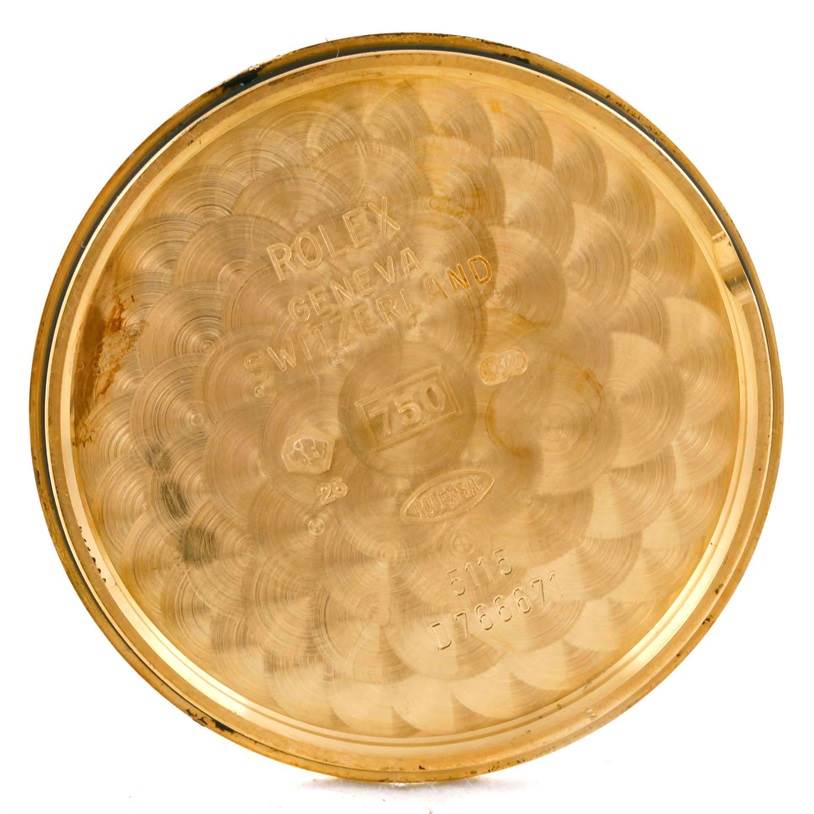 This image shows the inside of the case back of a Rolex Cellini 5115 Men
s Yellow Gold Champagne Dial 5115 Men
s Yellow Gold Champagne Dial watch, displaying various engravings.