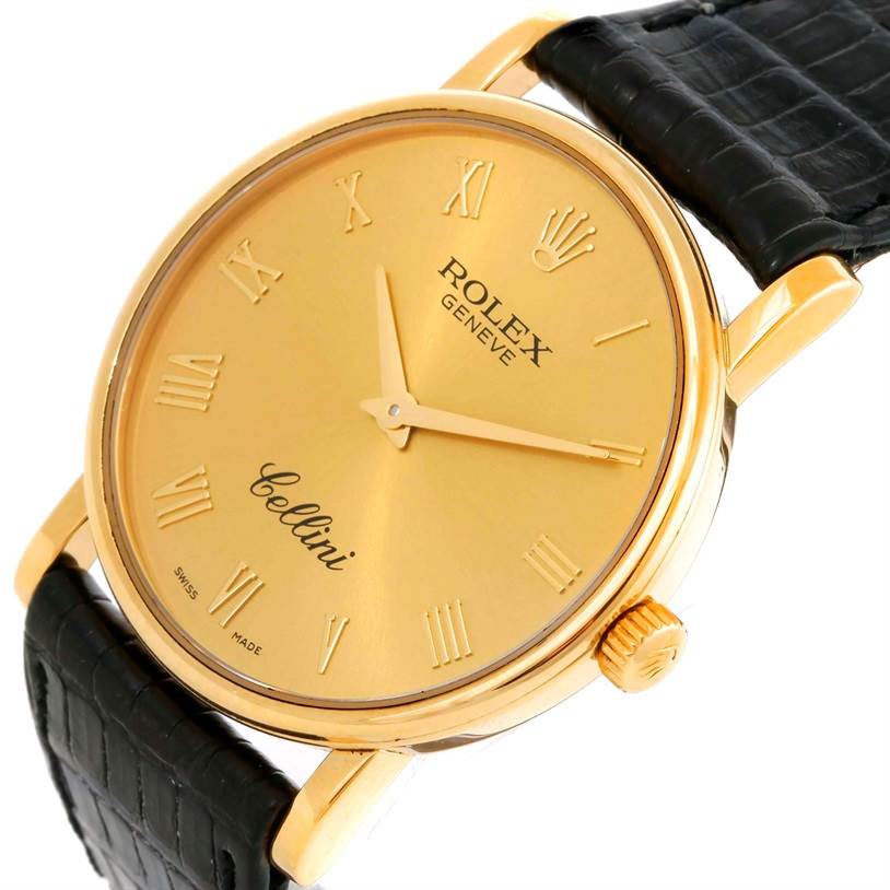 The image shows a Rolex Cellini 5115 Men
s Yellow Gold Champagne Dial 5115 Men
s Yellow Gold Champagne Dial watch at a slightly tilted angle, highlighting the gold case, Roman numeral dial, and black leather strap.