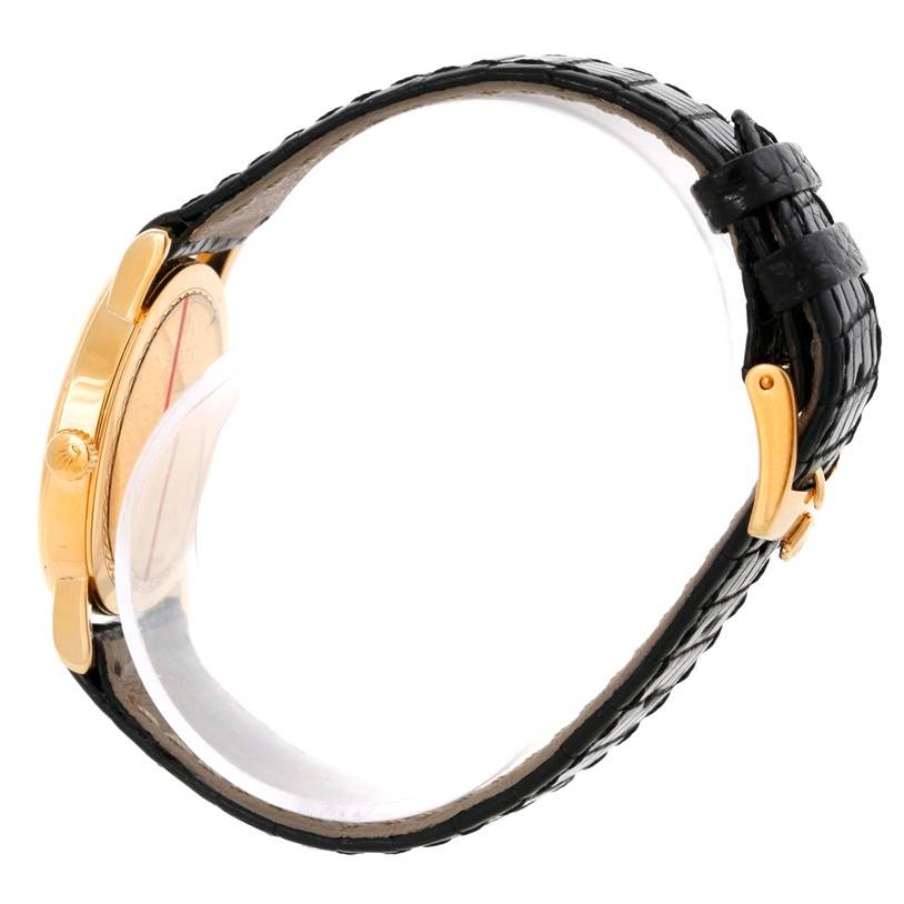 The image shows a Rolex Cellini 5115 Men
s Yellow Gold Champagne Dial 5115 Men
s Yellow Gold Champagne Dial watch from a side angle, featuring the crown, case, and black leather strap.