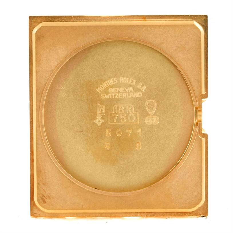 This image shows the back cover of a Rolex Cellini 5071 Men's Yellow Gold Champagne Dial 5071 Men's Yellow Gold Champagne Dial watch, highlighting the embossed brand details and gold markings.