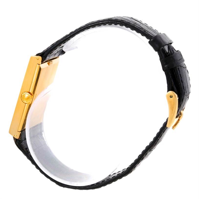 The image shows a side profile of a Rolex Cellini 5071 Men's Yellow Gold Champagne Dial 5071 Men's Yellow Gold Champagne Dial watch, displaying its gold case, crown, and black leather strap.