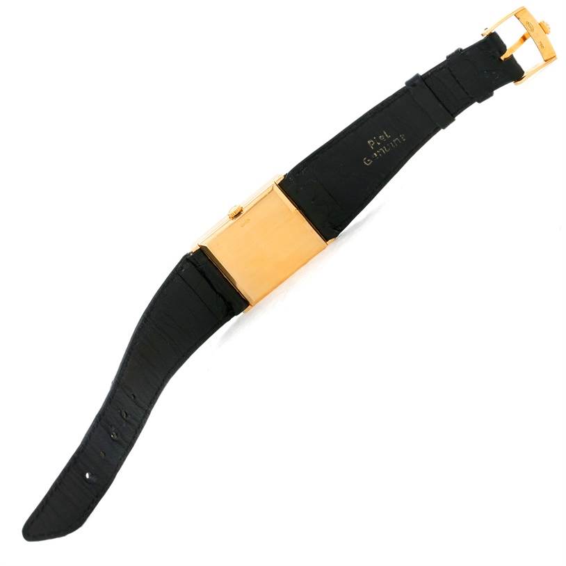 The image shows a Rolex Cellini 5071 Men's Yellow Gold Champagne Dial 5071 Men's Yellow Gold Champagne Dial watch from the back, highlighting its black strap and gold case.