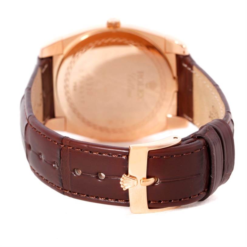 The image shows the back of a Rolex Cellini 5330 Men's Rose Gold Grey Dial 5330 Men's Rose Gold Grey Dial model watch, highlighting its leather strap and gold clasp.