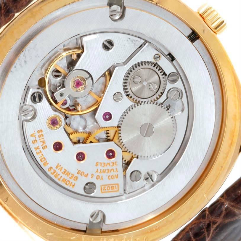 The image shows the movement and internal mechanisms of a Rolex Cellini 4233 Men
s Yellow Gold White Dial 4233 Men
s Yellow Gold White Dial watch from an internal angle.