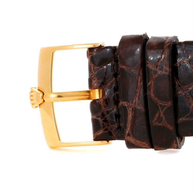 This image shows a close-up of the buckle and strap of a Rolex Cellini 4233 Men
s Yellow Gold White Dial 4233 Men
s Yellow Gold White Dial watch.