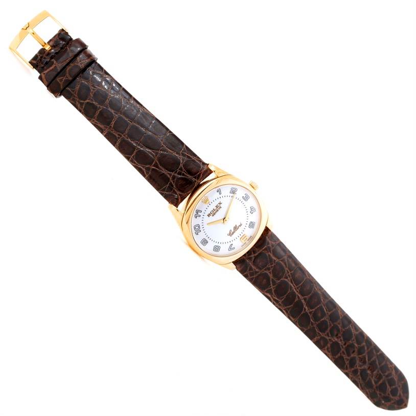 The Rolex Cellini 4233 Men
s Yellow Gold White Dial 4233 Men
s Yellow Gold White Dial watch is shown at a slight angle, displaying the face, case, and entire leather strap.