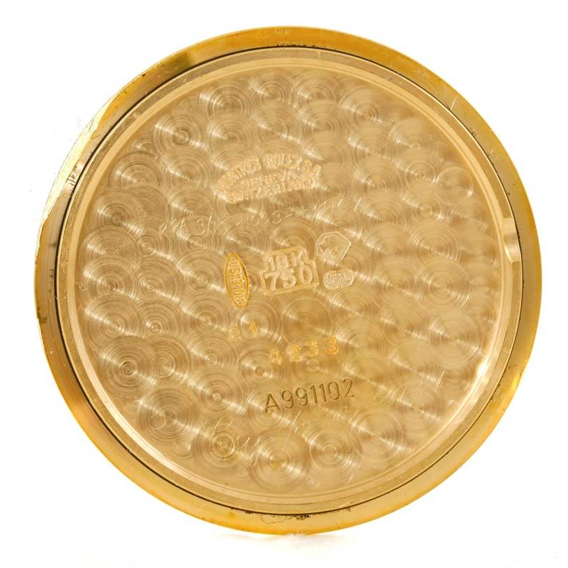 The image shows the inside of the case back of a Rolex Cellini 4233 Men
s Yellow Gold White Dial 4233 Men
s Yellow Gold White Dial watch with engravings and hallmarks visible.