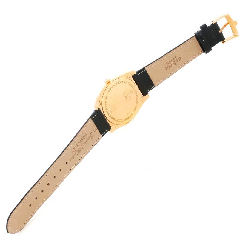 The image shows the back view of a Rolex Cellini 5330 Men's Yellow Gold White Dial 5330 Men's Yellow Gold White Dial watch, including its leather strap and gold case back.