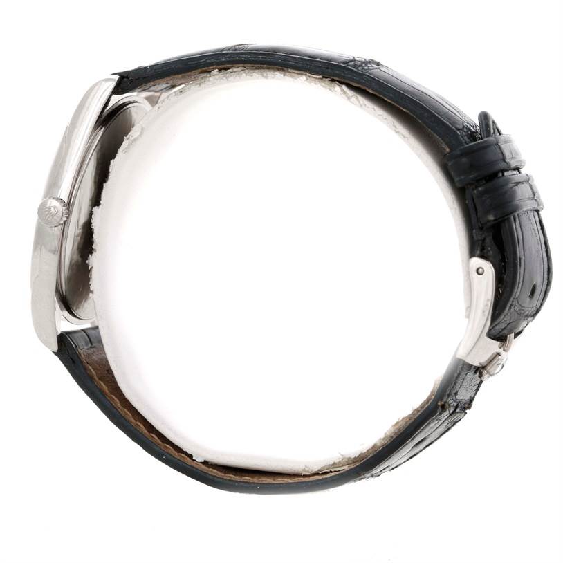 This Rolex Cellini 4233 Men's White Gold White Dial 4233 Men's White Gold White Dial model watch is shown from the side, displaying the crown, case, and black leather strap.