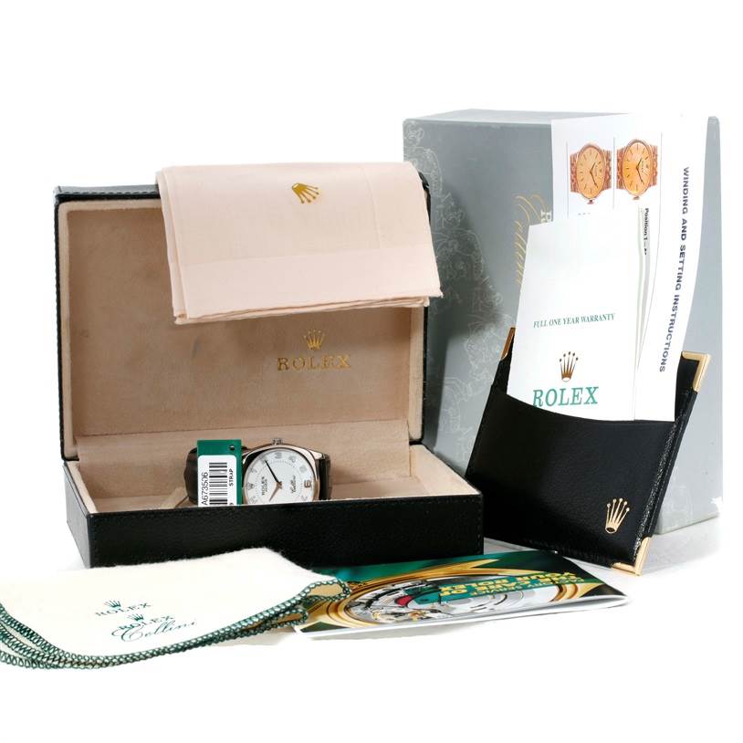 The image shows a Rolex Cellini 4233 Men's White Gold White Dial 4233 Men's White Gold White Dial watch with its box, warranty card, instruction booklets, and cleaning cloths.