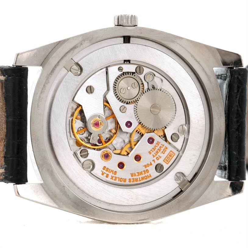 The image shows the Rolex Cellini 4233 Men's White Gold White Dial 4233 Men's White Gold White Dial model watch from the back, highlighting its inner mechanical movement.