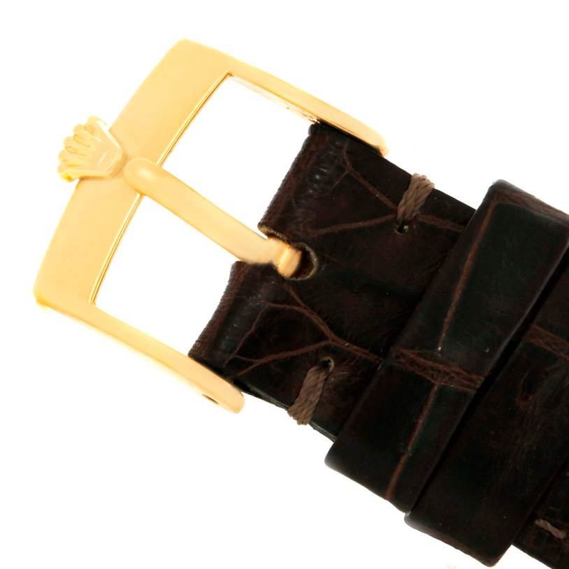 This image shows a close-up of the buckle and part of the leather strap of a Rolex Cellini 5116 Men
s Yellow Gold Black Dial 5116 Men
s Yellow Gold Black Dial watch.