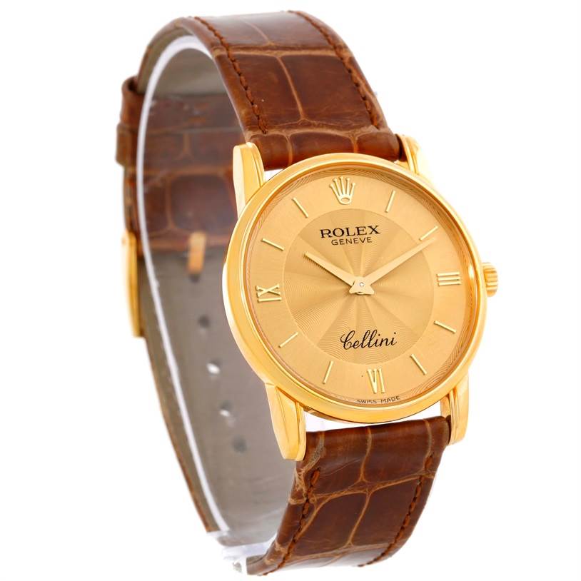 The image shows a Rolex Cellini 5116 Men
s Yellow Gold Champagne Dial 5116 Men
s Yellow Gold Champagne Dial model watch angled to display the gold dial, brown leather strap, and gold case.