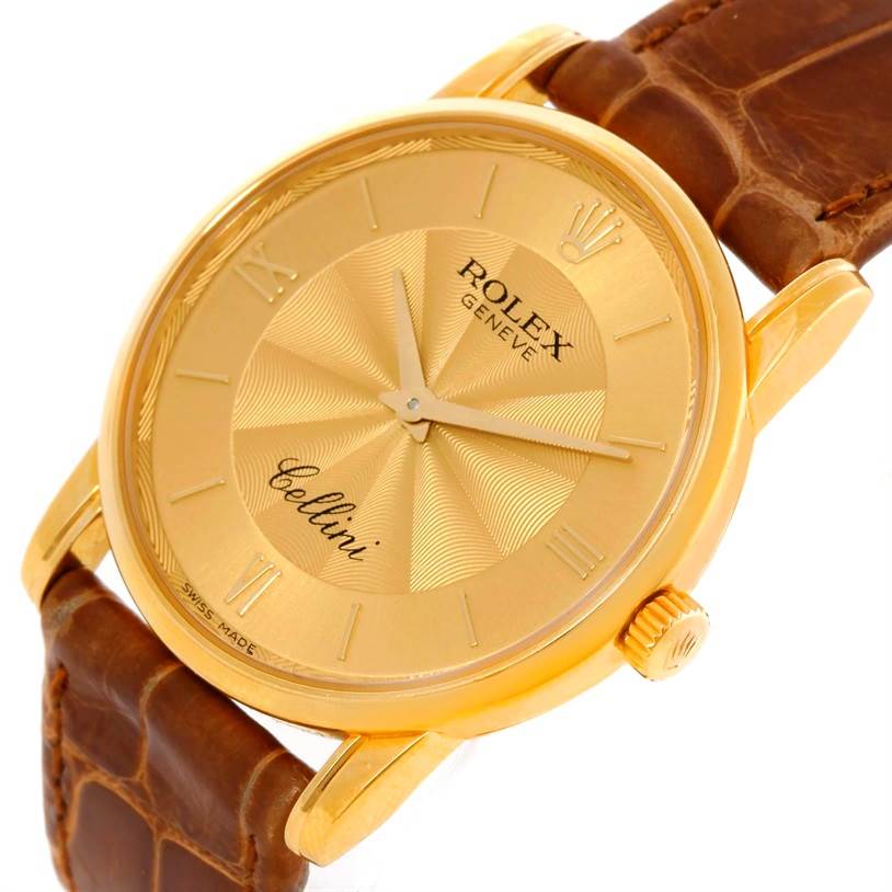 The image shows a close-up of the Rolex Cellini 5116 Men
s Yellow Gold Champagne Dial 5116 Men
s Yellow Gold Champagne Dial watch, displaying its gold dial, hands, crown, and brown leather strap.