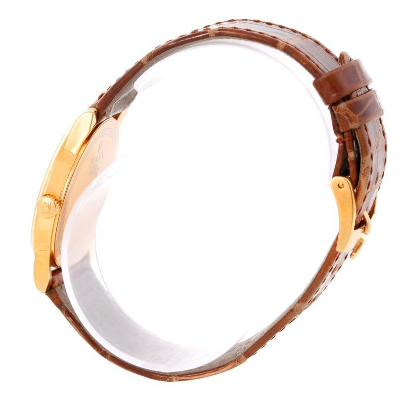 The image shows a side view of the Rolex Cellini 5116 Men
s Yellow Gold Champagne Dial 5116 Men
s Yellow Gold Champagne Dial watch, highlighting its brown leather strap and gold clasp.