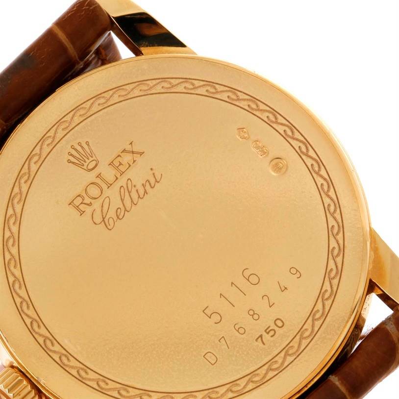The image shows the back case of a Rolex Cellini 5116 Men
s Yellow Gold Champagne Dial 5116 Men
s Yellow Gold Champagne Dial watch, with its model and serial numbers visible.