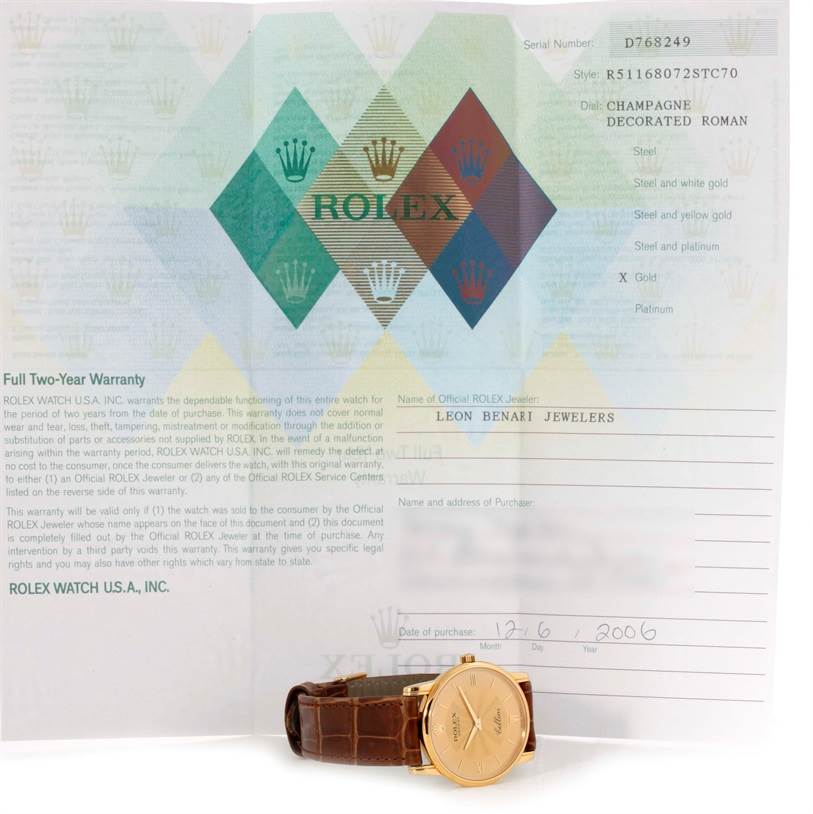 The image features a Rolex Cellini 5116 Men
s Yellow Gold Champagne Dial 5116 Men
s Yellow Gold Champagne Dial watch resting beneath an open warranty document.