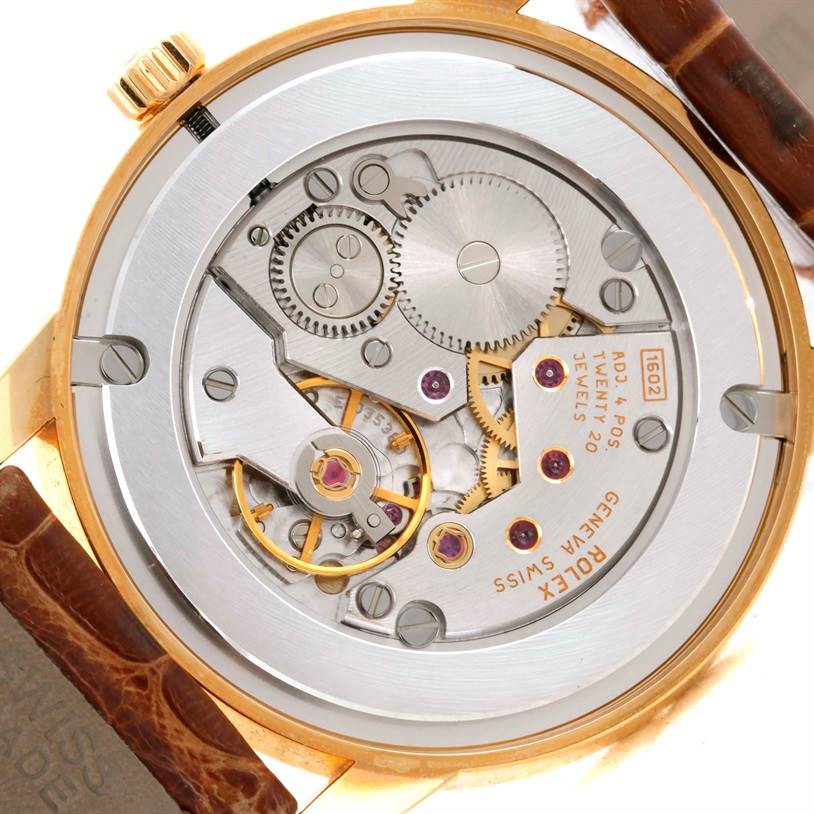 The image shows the back view of the Rolex Cellini 5116 Men
s Yellow Gold Champagne Dial 5116 Men
s Yellow Gold Champagne Dial watch, highlighting its intricate movement and internal components.