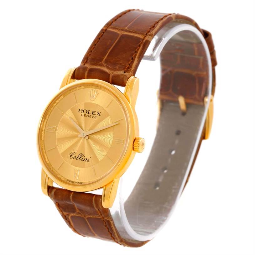 The Rolex Cellini 5116 Men
s Yellow Gold Champagne Dial 5116 Men
s Yellow Gold Champagne Dial watch is shown at a three-quarter angle, featuring a gold case, brown leather strap, and clear view of the dial.