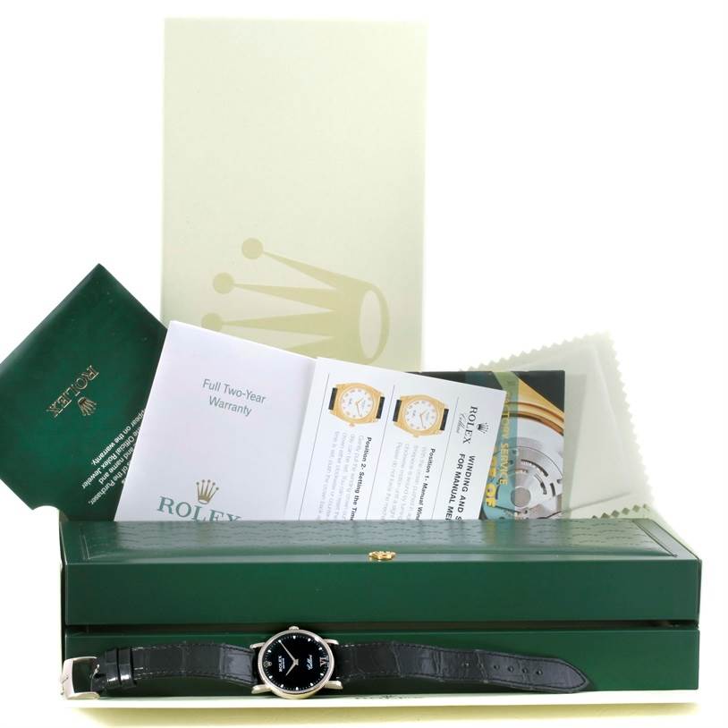 This image shows a Rolex Cellini 5115 Men's White Gold Black Dial 5115 Men's White Gold Black Dial watch along with its packaging, warranty, manuals, and a green case, displayed from the front.