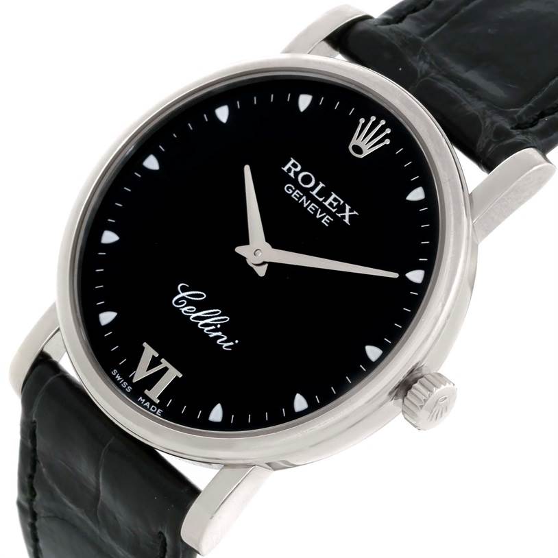 The Rolex Cellini 5115 Men's White Gold Black Dial 5115 Men's White Gold Black Dial watch is shown at a slight angle, highlighting its black dial, silver case, and crown, along with part of the strap.