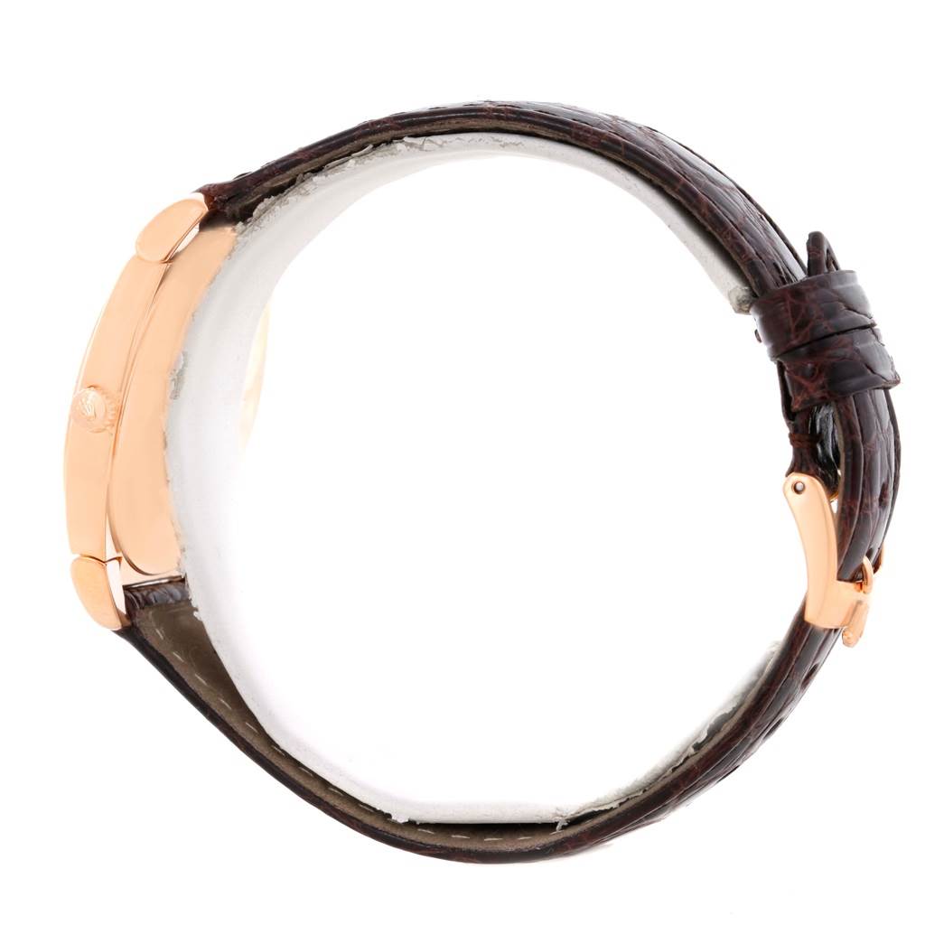 The image shows a side profile of a Rolex Cellini 5330 Men's Rose Gold White Dial 5330 Men's Rose Gold White Dial watch, highlighting its leather strap and gold case.