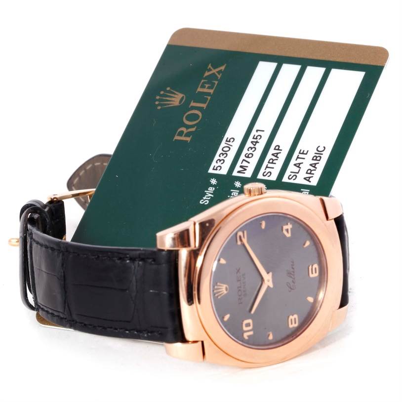 The image shows a Rolex Cellini 5330 Men's Rose Gold Grey Dial 5330 Men's Rose Gold Grey Dial watch with a slate dial and black strap, accompanied by a Rolex information card.