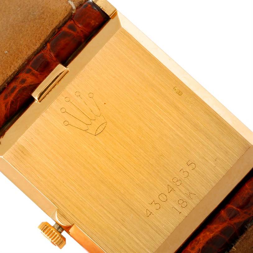 The image shows the back case of a Rolex Cellini 4014 Men's Yellow Gold Orange Dial 4014 Men's Yellow Gold Orange Dial watch, including the crown logo, serial number, and a portion of the leather strap.