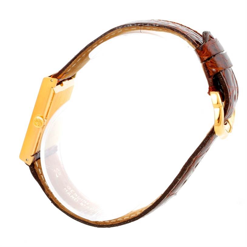 The image shows the side view of a Rolex Cellini 4014 Men's Yellow Gold Orange Dial 4014 Men's Yellow Gold Orange Dial watch, highlighting its case, crown, and strap.