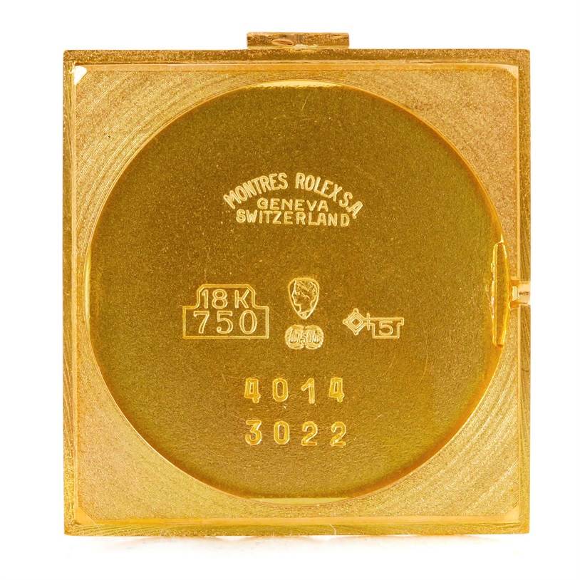 This image shows the back case of a Rolex Cellini 4014 Men's Yellow Gold Orange Dial 4014 Men's Yellow Gold Orange Dial watch, highlighting the engraved details and 18K gold stamp.