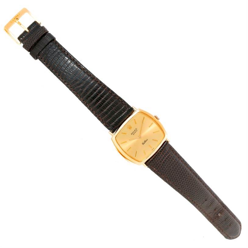 The Rolex Cellini 3805 Men's Yellow Gold Champagne Dial 3805 Men's Yellow Gold Champagne Dial watch is shown at an angled top-down view, displaying the entire timepiece including the dial, case, and strap.