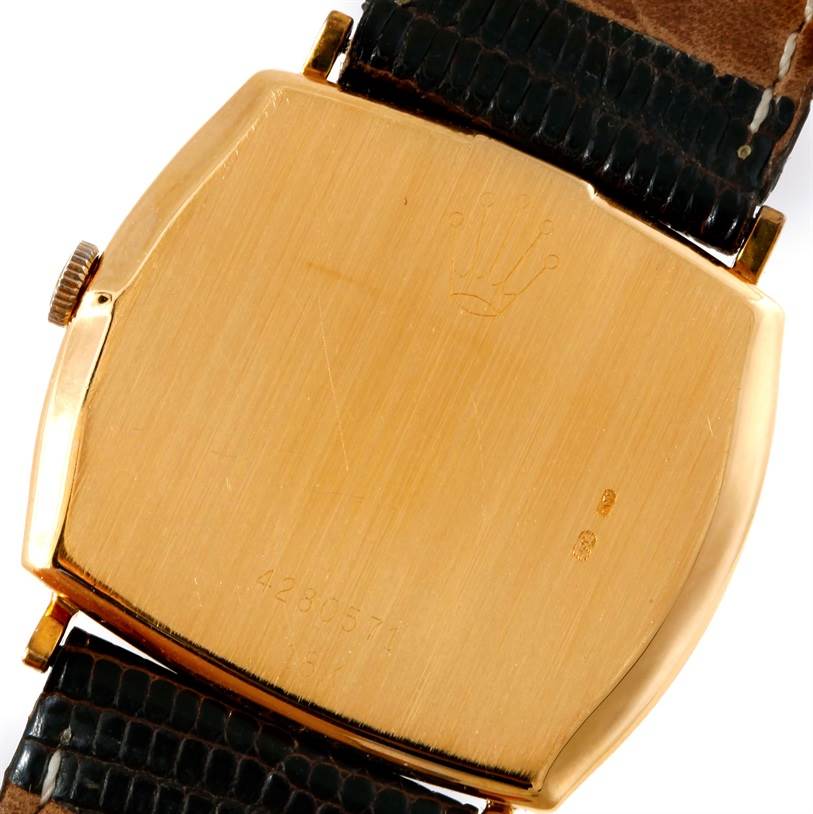 This image shows the back case of a Rolex Cellini 3805 Men's Yellow Gold Champagne Dial 3805 Men's Yellow Gold Champagne Dial watch, showcasing the crown logo and leather strap attachments.