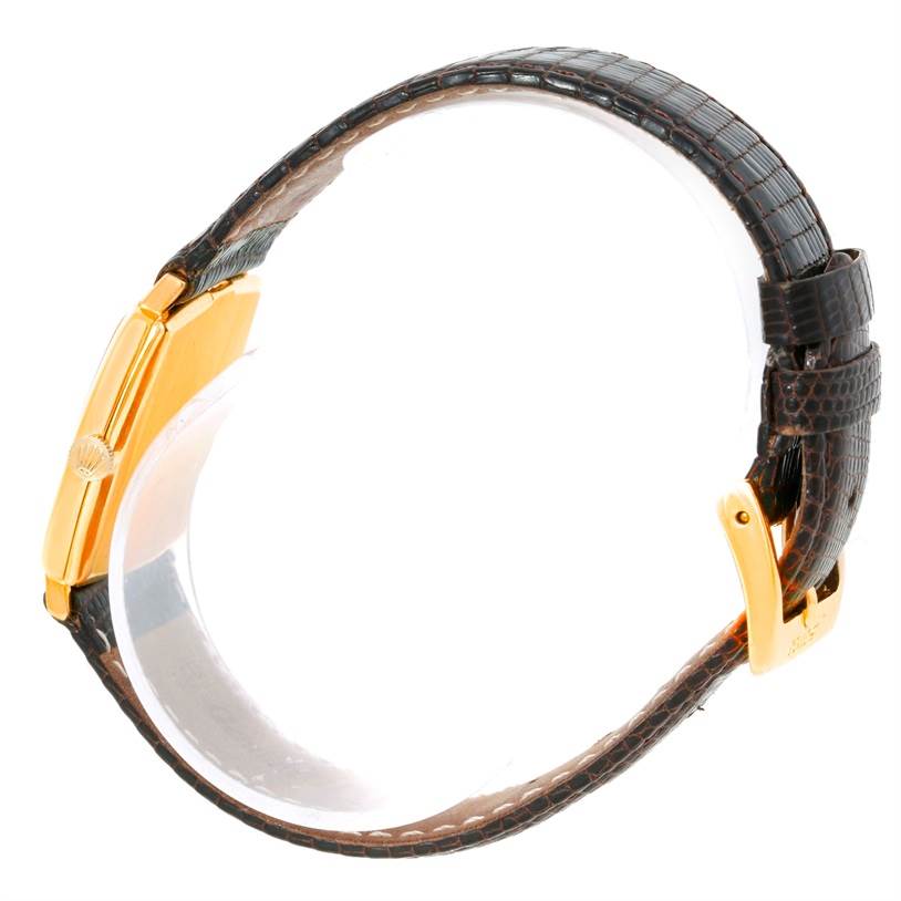 The Rolex Cellini 3805 Men's Yellow Gold Champagne Dial 3805 Men's Yellow Gold Champagne Dial watch is shown from a side angle, displaying the bezel, crown, and leather strap.