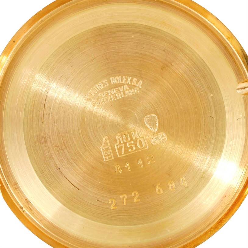 The image shows the inside case back of a Rolex Cellini 4112 Men
s Yellow Gold Champagne Dial 4112 Men
s Yellow Gold Champagne Dial watch, revealing the gold content and brand markings.